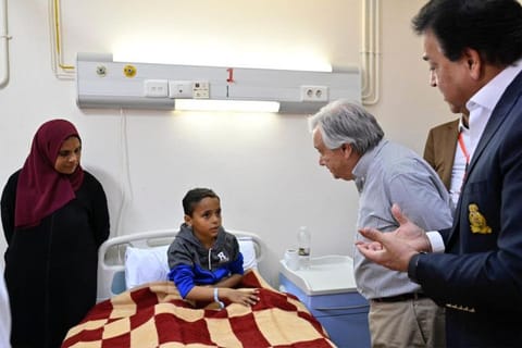 UN Secretary-General Antonio Guterres meeting with a Palestinian child evacuated from the Gaza Strip receiving treatment at the general hospital in Al Arish in Egypt's northeastern North Sinai province on March 23, 2024.