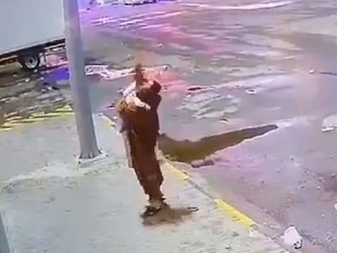 A security guard carries the girl after the fall.