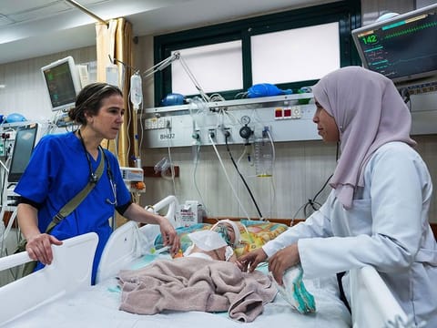 Pediatrician Tanya Haj-Hassan, left, examines wounded children at Al Aqsa Martyrs Hospital in Deir al-Balah, central Gaza.