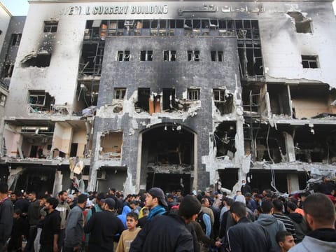 Palestinians inspect the damage outside Gaza's Al Shifa hospital after the Israeli military withdrew from the complex on April 1, 2024.