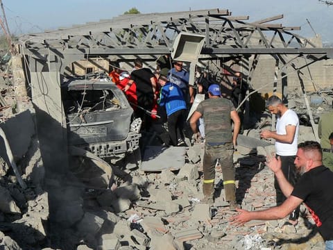 Emergency responders dig through the rubble of a building after an Israeli strike on a house in Lebanese town of Marjayoun on April 5, 2024, during a cross-border exchange between Lebanon and Israel.