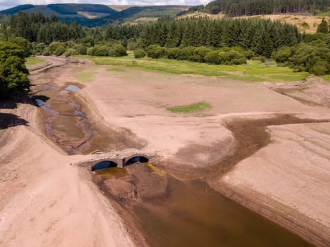 Aerial drone view of a dried up reservoir during a drought in the UK (Llwyn-On Reservoir)
