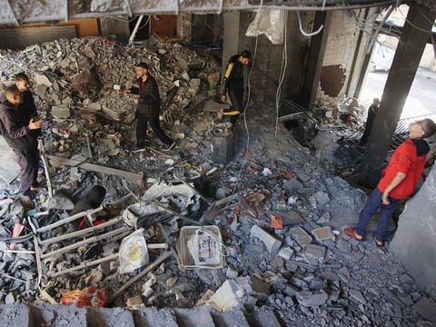 Palestinians inspect the damage to the home of the Tabatibi family after Israeli bombardment in the Daraj Neighbourhood of Gaza on April 12, 2024.