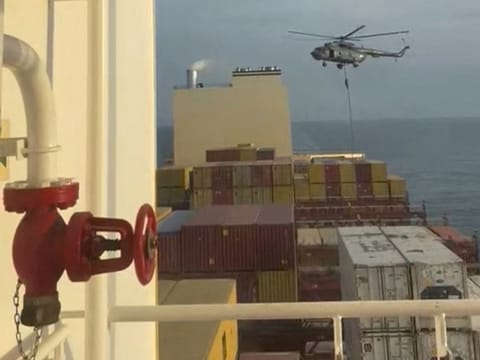 An official slides down a rope during a helicopter raid on MSC Aries ship at sea in this screen grab obtained from a social media video released on April 13, 2024.