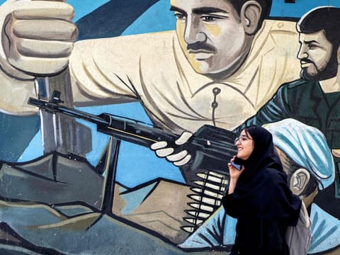 An anti-Israeli mural depicting fighters with assault rifles along a wall in Palestine Square in Tehran on April 14, 2024.