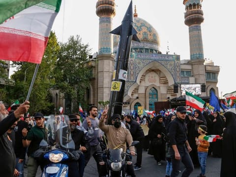 Iranians celebrate following Iran's missiles and drones attack on Israel, on April 15 2024, at Palestine square in central Tehran.