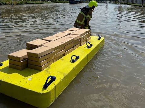 A Dubai Civil Defence team member distributing supplies on April 17 after record rainfall