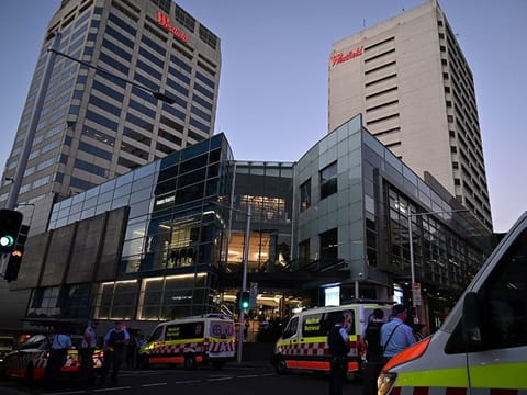 Emergency service workers stand near Bondi Junction after multiple people were stabbed inside the Westfield Bondi Junction shopping centre in Sydney