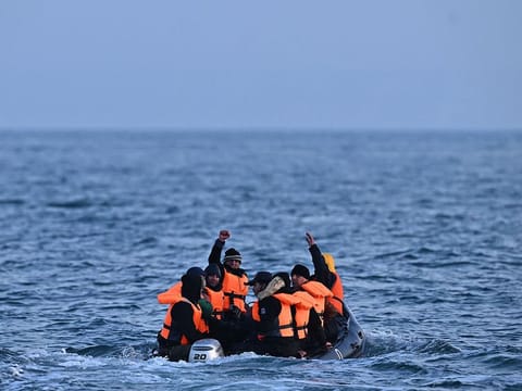 Migrants travel in an inflatable boat across the English Channel, bound for Dover on the south coast of England.