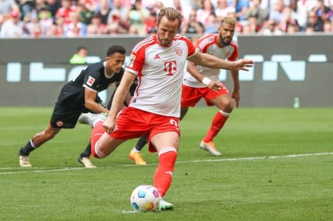 Bayern Munich's English forward Harry Kane scores the 2-1 goal from the penalty spot during the German first division Bundesliga football match against Eintracht Frankfurt in Munich on Saturday.