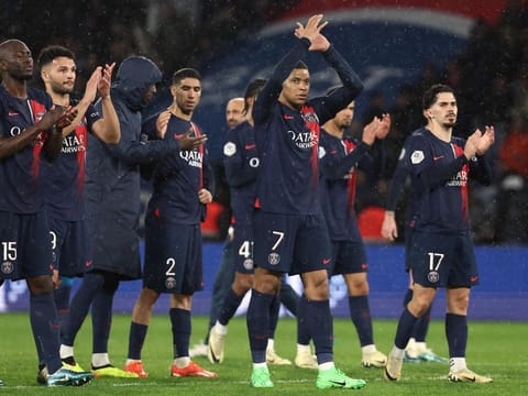 Paris Saint-Germain's forward Kylian Mbappe (centre) and teammates applaud supporters at the end of the French L1 football match against Le Havre AC at the Parc des Princes Stadium in Paris on April 27.