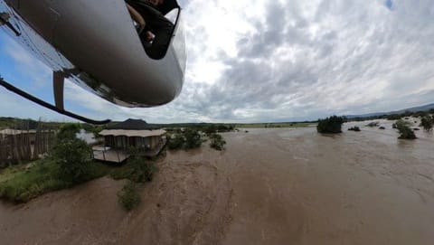 A view from a helicopter shows a safari lodge near the swollen river within the flooded area following heavy rainfall in the Talek region, of the Maasai Mara National Reserve in southwestern Kenya.