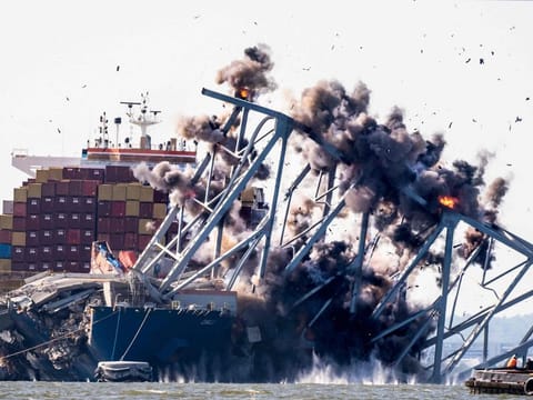 Crews conduct a controlled demolition of a section of the Francis Scott Key Bridge resting on the Dali container ship in Baltimore on May 13, 2024.