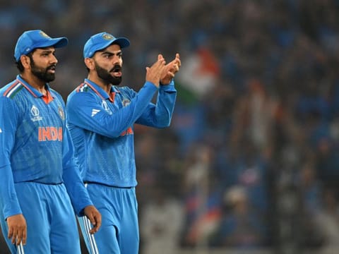 India's captain Rohit Sharma and teammate Virat Kohli celebrate after the dismissal of Australia's Mitchell Marsh during the 2023 ICC Men's Cricket World Cup O-day International final match at the Narendra Modi Stadium in Ahmedabad on November 19, 2023.