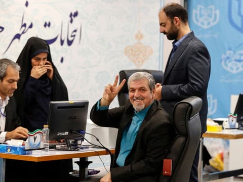 Iranian politician Mostafa Kavakebian gestures as he registers at a registration office, in Tehran on May 30, 2024, ahead of the country's presidential election.