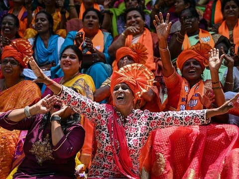 Supporters of the Bharatiya Janata Party (BJP) celebrate as they watch the vote counting results
