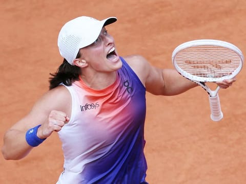 Poland's Iga Swiatek celebrates her victory over Italy's Jasmine Paolini after their women's singles final match of the French Open tennis tournament at the Roland Garros Complex in Paris on June 8, 2024.