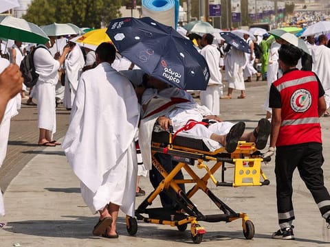 Medics tend to a man who had a heat stroke as pilgrims make their way towards Saudi Arabia's Mount Arafat on June15, 2024..