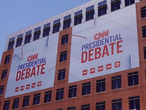 Signs advertising the presidential debate hosted by CNN are seen outside their studios on June 25, 2024 in Atlanta, Georgia. US President Joe Biden and Republican presidential candidate former President Donald Trump will face off in the first presidential debate of the 2024 presidential cycle on Friday, 5am (UAE time).