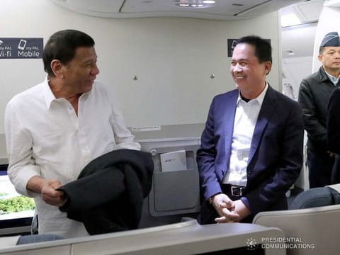 Former President Rodrigo Duterte shares a light moment with the Kingdom of Jesus Christ sect pastor Apollo Quiboloy while on board a plane bound for Davao City on October 5, 2019.