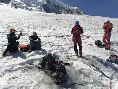 Handout picture released by Peruvian National Police shows police officers next to the body of US mountain climber William Stampfl, who was reported missing in June 2002, in the Ancash region, 400 km north of Lima.