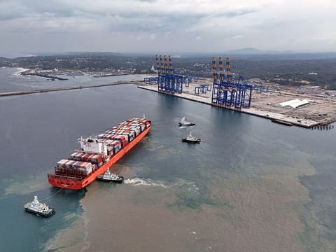 Tugboats offer water salute to MV San Fernando as they steer the mothership from China, through the breakwater channel to the Vizhinjam International Seaport, in Thiruvananthapuram on July 11, 2024.