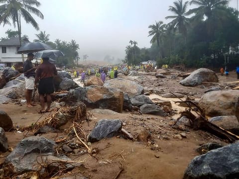 Relief personnel conduct a search and rescue operation at a site following landslides in Wayanad on July 30, 2024.