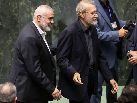 Haniyeh (left) walks next to ex-parliament speaker Ali Larijani during a swearing in ceremony for the new president at the parliament in Tehran, on July 30 2024. Doha-based Haniyeh, who the day earlier had attended the inauguration of new Iranian President Masoud Pezeshkian, was killed in the early hours of Wednesday at a residence in northern Tehran, according to Iran’s Revolutionary Guards.