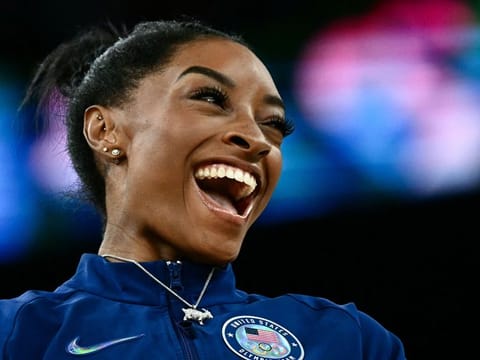 USA’s Simone Biles poses with her goat necklace after the artistic gymnastics women’s all-around final during the Paris 2024 Olympic Games on August 1, 2024. It was Biles second all-around gold, making her only the third woman to achieve the feat.