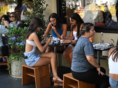 People eat at a restaurant in downtown Beirut on August 2, 2024. France, Canada and Jordan were among the latest governments to issue calls for their citizens to leave Lebanon.
