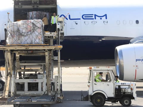 Workers unload medical supplies delivered by the World Health Organization (WHO) as a prevention of any potential health crisis that might result from a major conflict in Lebanon, at Beirut International Airport on August 5, 2024.