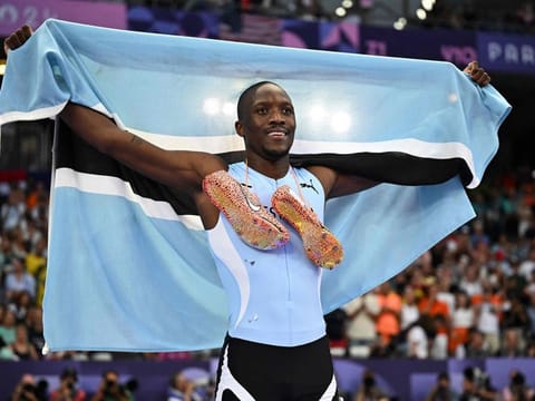 Gold medallist Botswana's Letsile Tebogo celebrates with the national flag after winning the men's 200m final of the athletics event at the Paris 2024 Olympic Games at Stade de France in Saint-Denis, north of Paris, on Thursday.