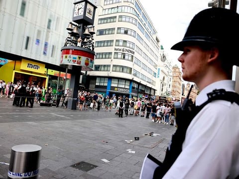 A photograph taken on August 12, 2024 shows a police officer standing by a cordoned off area in Leicester square, London.