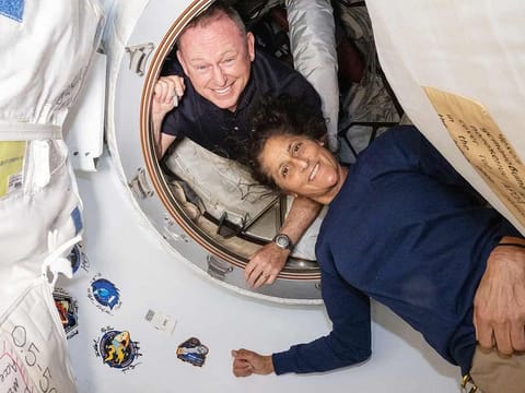 NASA’s Boeing Crew Flight Test astronauts (from top) Butch Wilmore and Suni Williams inside the vestibule between the forward port on the International Space Station’s Harmony module and Boeing's Starliner spacecraft.