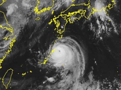 This handout image taken from the Japan Meteorological Agency's satellite ‘Himawari’ on August 27, 2024 shows typhoon Shanshan (C) moving closer the Japan's Amami island area.