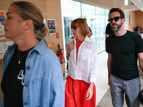 Gisele P. (C), escorted by her son Florian P. (R) and her daughter Caroline Darian (L), arrives at the courthouse.