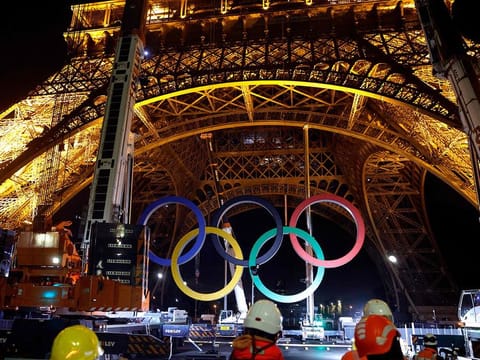 Cranes remove the Olympic rings from the Eiffel Tower in Paris, on September 27, 2024.