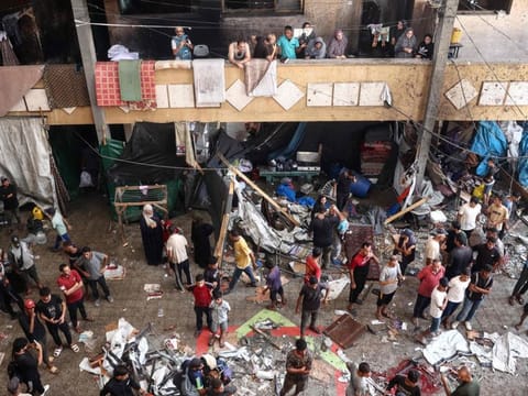 Palestinians react after an Israeli strike hit the Rafida school housing displaced people in Deir Al Balah in the central Gaza Strip, on October 10, 2024.