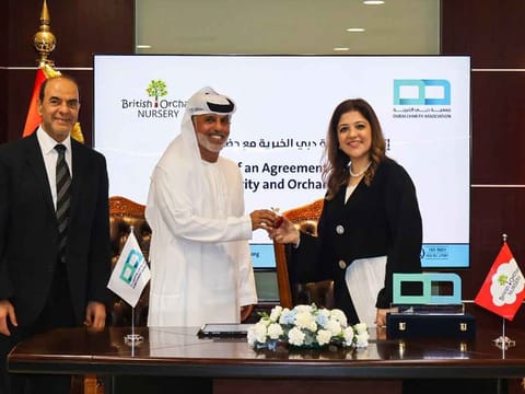 Ahmed Al Suwaidi, Executive Director of Dubai Charity Association, and Dr. Vandana Gandhi, Founder and CEO of Orchard Nursery, sign the agreement at Dubai Charity Association's headquarters