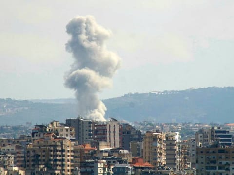 A picture taken from the southern Lebanese city of Tyre shows smoke rising from the site of an Israeli strike targeting the village of Qana.