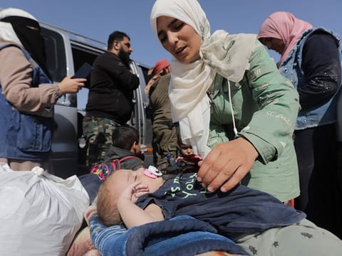 Syrians who were refugees in Lebanon return to their home country after a journey to the opposition held northern Idlib province through the crossing Aoun al-Dadat north of Manbij.