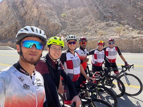 Nathan Irvine, with other cycling enthusiasts at the bottom of Jebel Jais after a climb to the top. The cycling community of UAE express their love and passion for the sport, and how it helps them focus on their fitness and well-being.