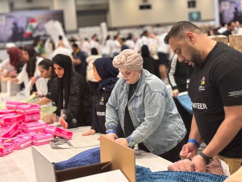 Volunteers from different nationalities formed neat rows to assemble the relief kits