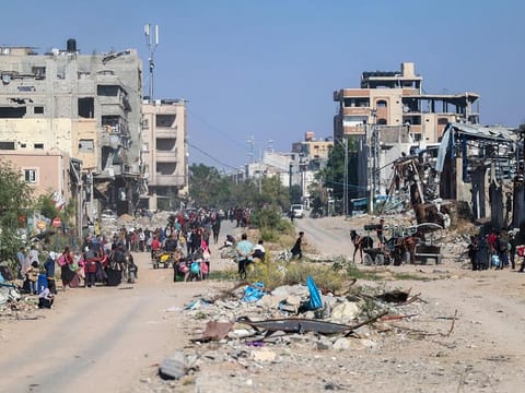 Displaced Palestinians fleeing Israeli military operations in Beit Lahia in the northern Gaza strip walk along the Salah Al Din main road in eastern Gaza City making their way to the city centre, on October 22, 2024, amid the ongoing war in the Palestinian territory between Israel and Hamas.