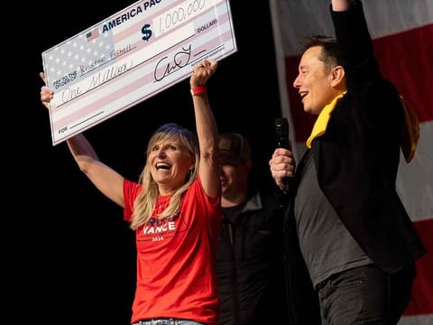 SpaceX and Tesla founder Elon Musk awarded Kristine Fishell with a $1 million check during the town hall at the Roxain Theater on October 20, 2024 in Pittsburgh, Pennsylvania.