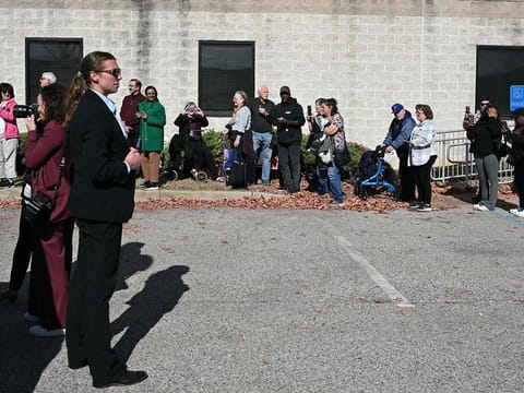 People wait in line to cast their early-voting ballots in the 2024 general election in New Castle, Delaware, October 28, 2024.