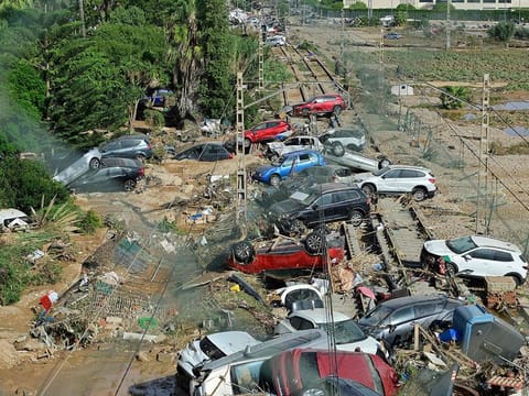 Wreckage of cars pile up on the on the railway on October 31, 2024 after flash floods ravaged the town of Alfafar, in the region of Valencia, eastern Spain.