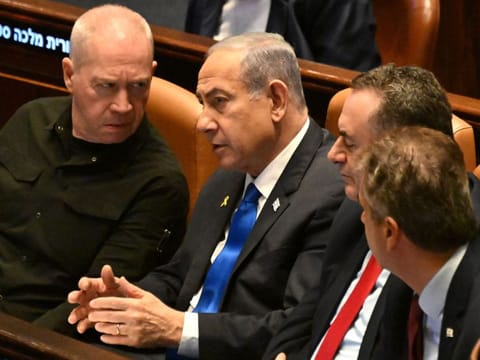 Netanyahu (centre) speaks to Gallant at the opening of the 25th Parliament session in Jerusalem on October 28, 2024.