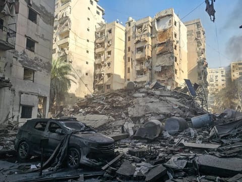 A damaged car lies amid the heavy destruction in the aftermath of an Israeli airstrike that targeted the neighbourhood of Rweiss in Beirut's southern suburbs on November 14, 2024.