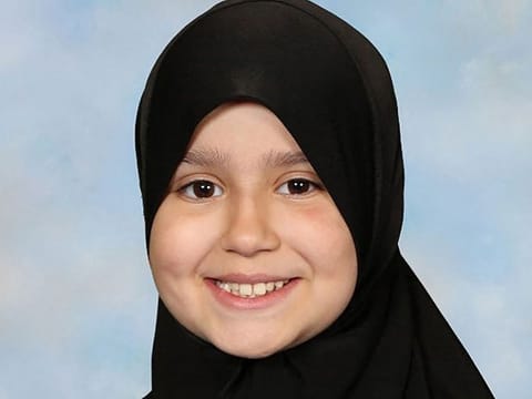 This undated handout photograph released by Surrey Police on October 17, 2024, shows British-Pakistani girl Sara Sharif posing for a portrait wearing a hijab. Beatings, human bites, fractures, iron burns, confinement: nothing had been spared ten-year-old Sara Sharif, killed in the family home in August 2023, and whose father, stepmother and uncle are currently on trial in London.